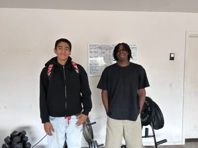 Two young athletes in From A Cub Athletics gear standing together